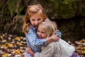 Two young girls hugging each other
